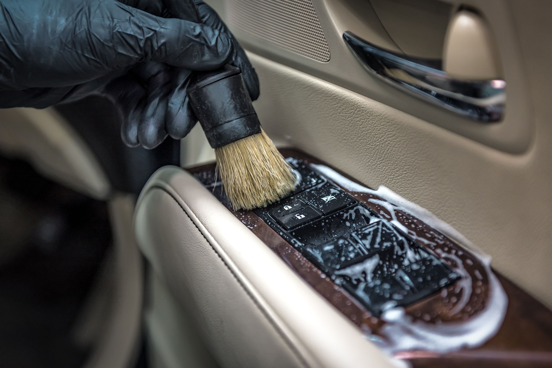 Spécialiste du nettoyage de la voiture avec du sud et de la brosse. Esthétique automobile. Mise au point sélective. Esthétique automobile. Concept de solution de lavage et de nettoyage